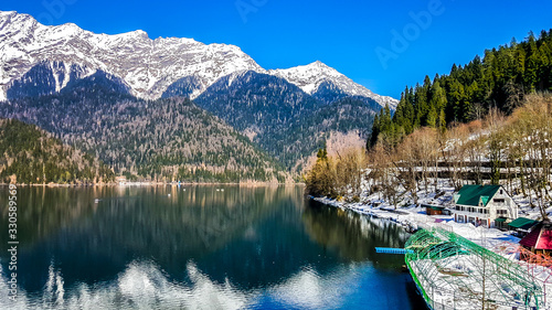 Fototapeta Naklejka Na Ścianę i Meble -  Lake Ritsa in the Caucasus Mountains, in the north-western part of Abkhazia, surrounded by mixed mountain forests and subalpine meadows.