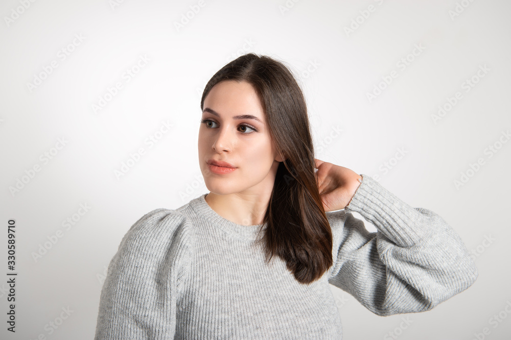 Horizontal studio portrait of a beautiful brunette wearing little makeup. Simple attractive next door girl beauty lifestyle concept Horizontal studio portrait of a beautiful brunette wearing little makeup. Simple attractive next door girl beauty lifestyle concept