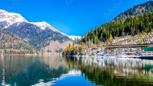 Lake Ritsa in the Caucasus Mountains, in the north-western part of Abkhazia, surrounded by mixed mountain forests and subalpine meadows.