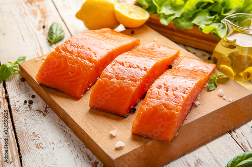Raw salmon fillet on table