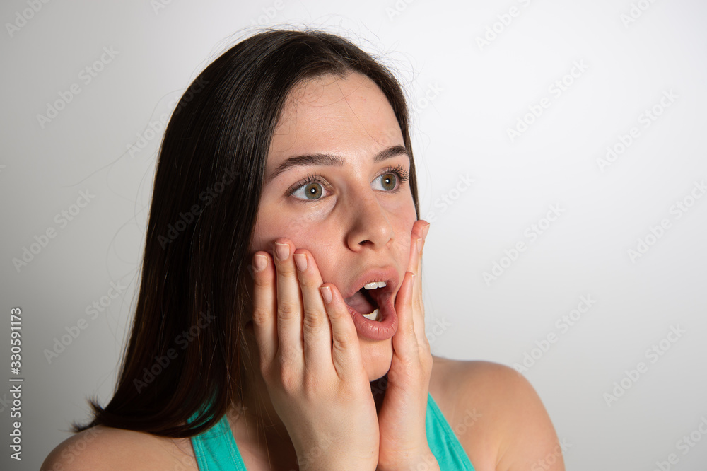 Surprised expression on the face of a pretty young woman. Human emotions body language concept Surprised expression on the face of a pretty young woman. Human emotions body language concept