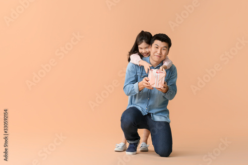 Happy Asian man with gift a...