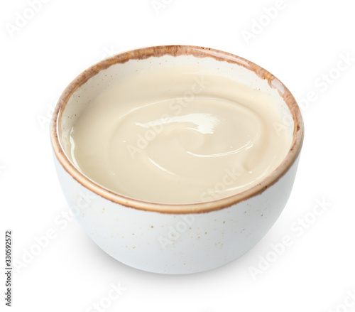 Bowl with tasty cream cheese on white background