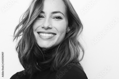 Stampa su tela Black and white portrait of young happy woman with a big smile on her face