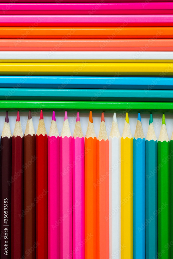Bright Colored pencils arranged in a row vertically and horizontally. Bright Colored pencils arranged in a row vertically and horizontally.