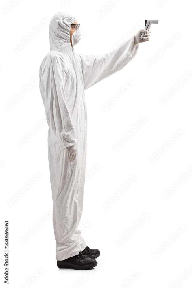 Man in a hazmat suit scanning temperature with a thermometer Man in a hazmat suit scanning temperature with a thermometer