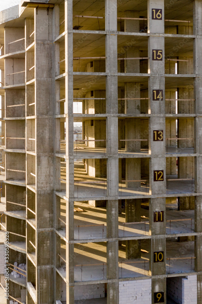 Aerial view of concrete frame of tall apartment building under construction in a city Aerial view of concrete frame of tall apartment building under construction in a city