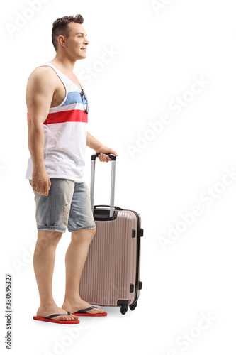 Male tourist with a suitcase on a summer holiday