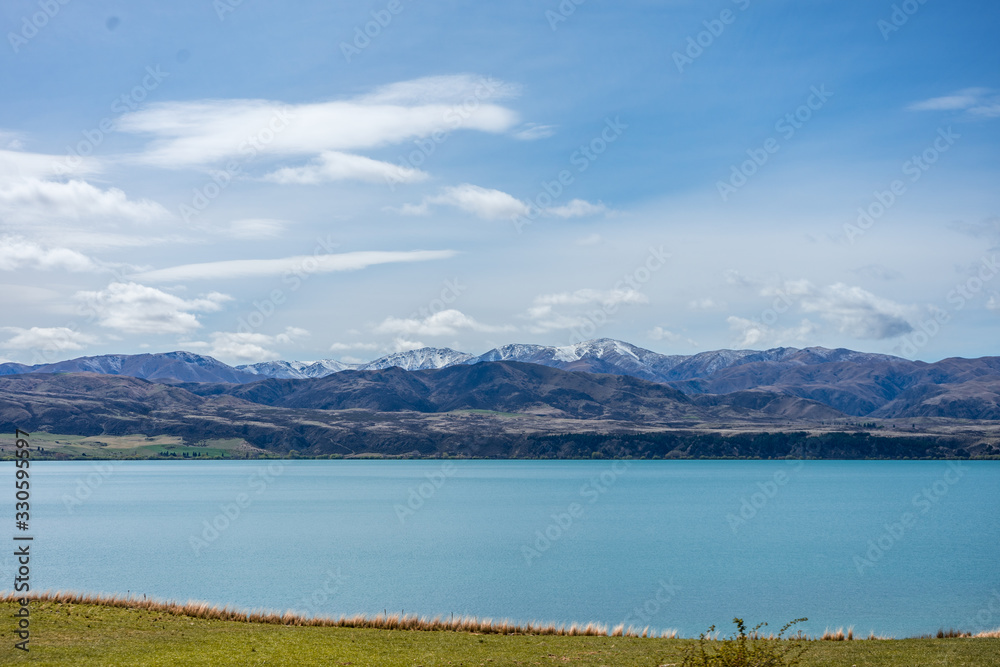 Beautiful river with snowy mountains in the background taken on a sunny day, New Zealand
