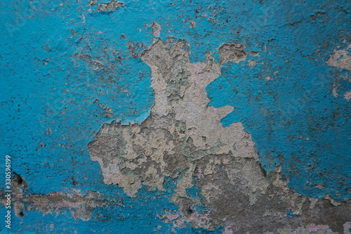 Old blue paint peeling on concrete wall, abstract background, Selective focus 