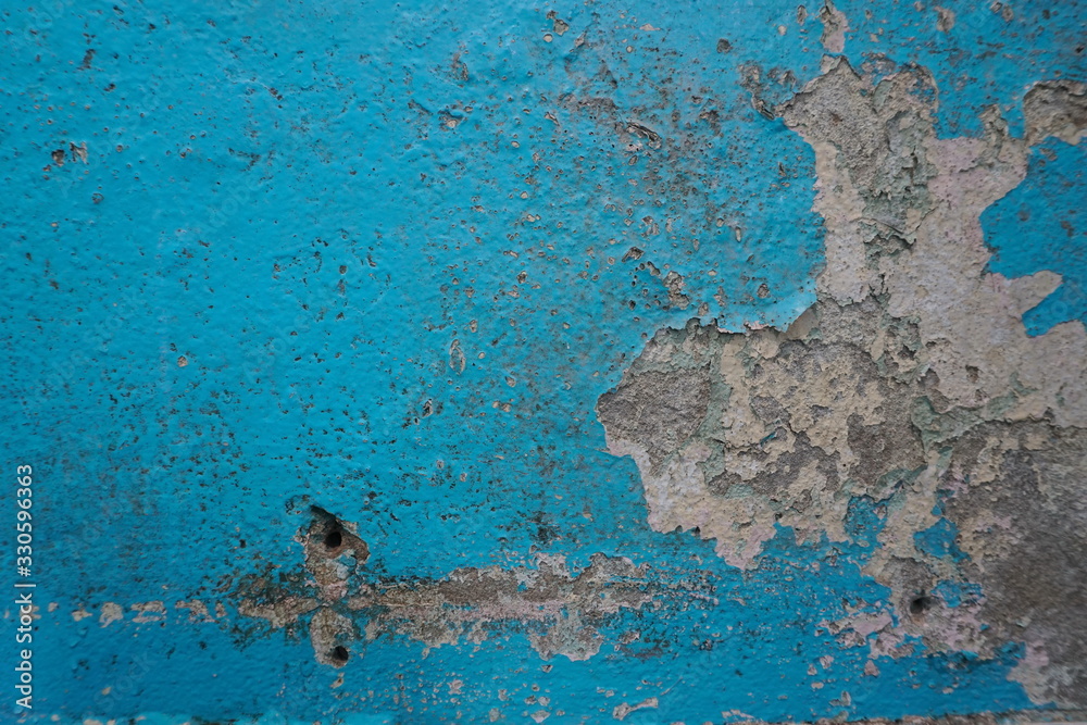 Old blue paint peeling on concrete wall, abstract background, Selective focus 