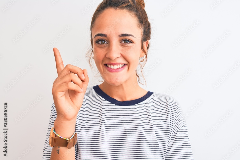 Young redhead modern woman wearing a bun over isolated background very happy pointing with hand and finger to the side Young redhead modern woman wearing a bun over isolated background very happy pointing with hand and finger to the side