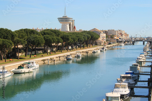 The Lez, a coastal river,  and the lighthouse of the Mediterranean, an ancient water tower in Palavas les flots, France