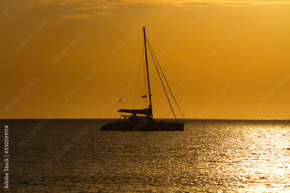 Beautiful sunset with silhouette sailing boat over the sea in Sabah Malaysia