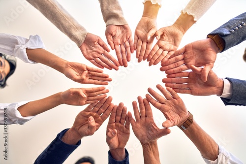 Group of business workers standing doing symbol with fingers together at the office