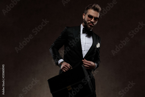 Dramatic fashion businessman unbuttoning his jacket