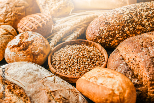 Various kind of bread with wheat top view. White bakery food concept panorama or wide banner photo.