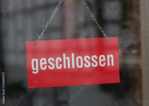 sign with the german word for closed (geschlossen) on a shop