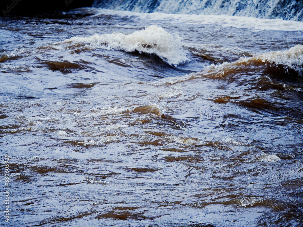 Waves and plashes of water in river, Concept flood, power of nature. Waves and plashes of water in river, Concept flood, power of nature.