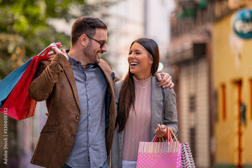 Happy smiling couple with shopping bags Happy smiling couple with shopping bags