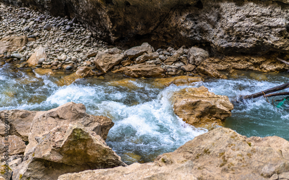 The rapid flow of a mountain river The rapid flow of a mountain river