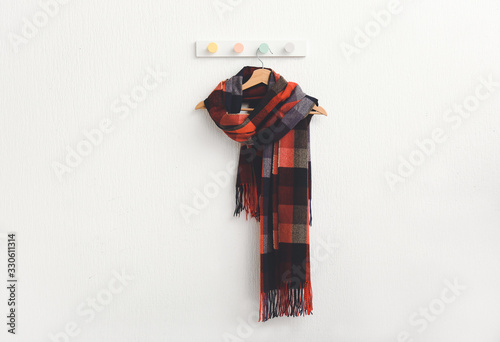 Hanger with beautiful scarf on white background