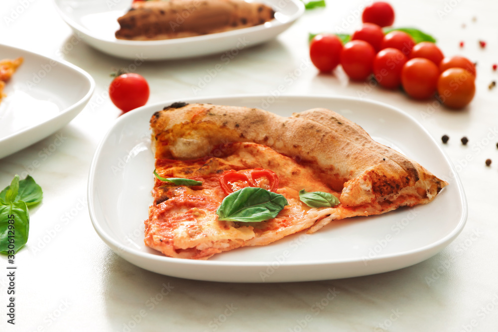 Plate with slice of delicious pizza Margherita on table Plate with slice of delicious pizza Margherita on table