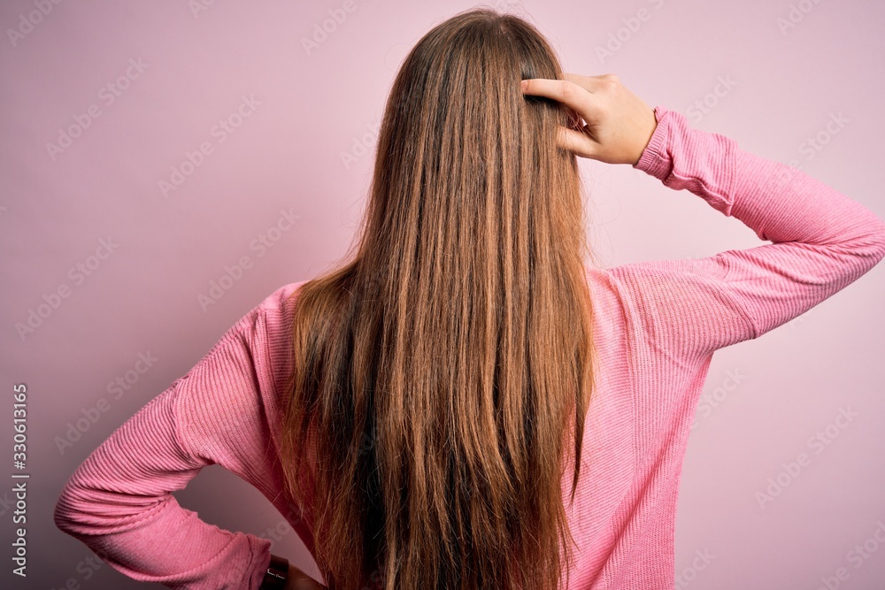 Young beautiful redhead woman wearing casual sweater over isolated pink background Backwards thinking about doubt with hand on head Young beautiful redhead woman wearing casual sweater over isolated pink background Backwards thinking about doubt with hand on head