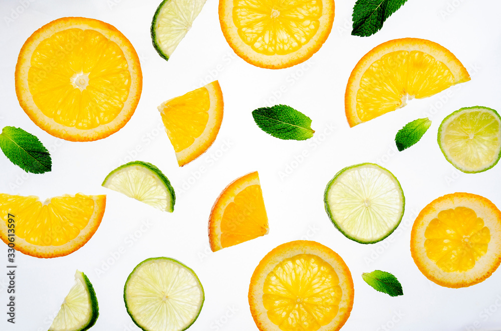 Sliced citrus fruits background. Oranges, lime and fresh mint. Sliced citrus fruits background. Oranges, lime and fresh mint.