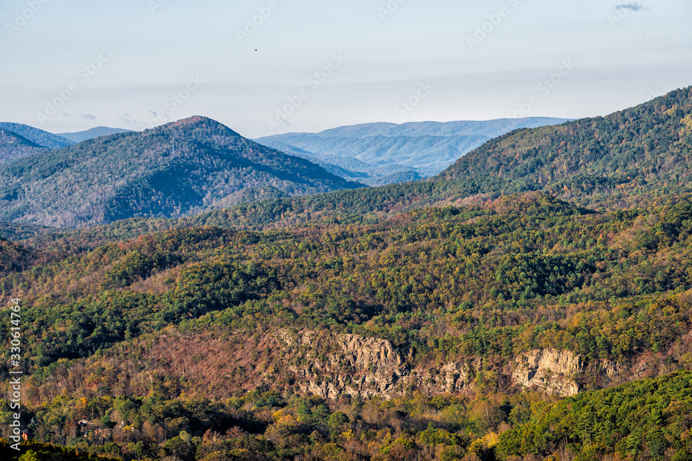 Sunny panoramic view of Appalachian mountains and green forest trees in rural countryside in Virginia by WV border in morning autumn