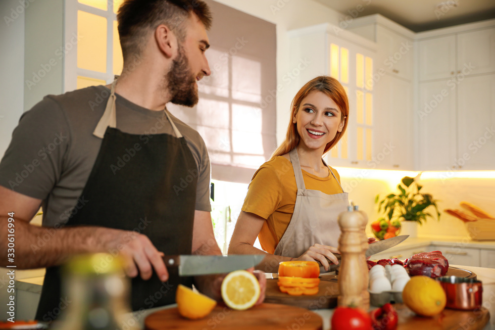 Happy people cooking food together in kitchen Happy people cooking food together in kitchen