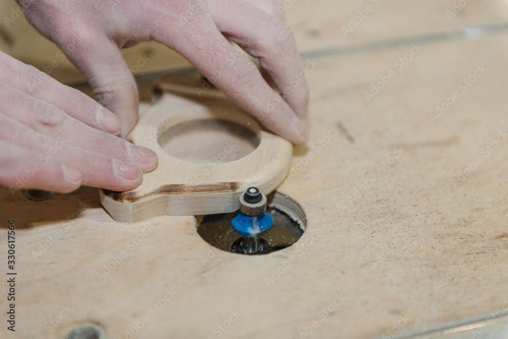 A man carves a toy on the machine. Making wooden toys. Toys made of wood. Safe toys. Educational toys, sand wooden toys A man carves a toy on the machine. Making wooden toys. Toys made of wood. Safe toys. Educational toys, sand wooden toys