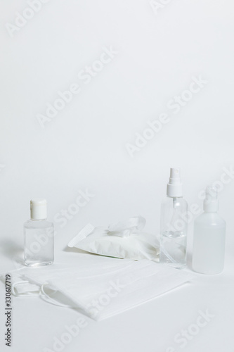Antiseptic gel, sanitary napkins, medical mask, antibacterial spray on a white background. Personal protective hygiene concept. Prevention of coronavirus disease (COVID-19) . Copy space