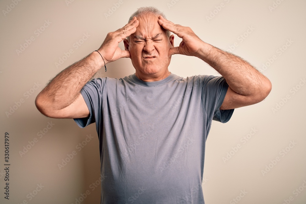 Middle age handsome hoary man wearing t-shirt standing over isolated white background suffering from headache desperate and stressed because pain and migraine. Hands on head. Middle age handsome hoary man wearing t-shirt standing over isolated white background suffering from headache desperate and stressed because pain and migraine. Hands on head.
