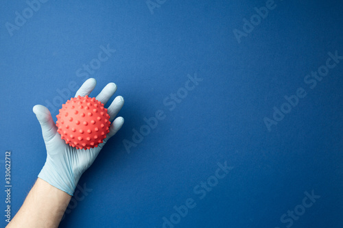 Hand in sterile glove studies the mock up of virus