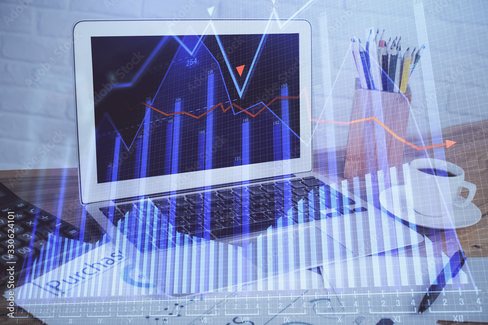 Financial chart drawing and table with computer on background. Multi exposure. Concept of international markets. Financial chart drawing and table with computer on background. Multi exposure. Concept of international markets.