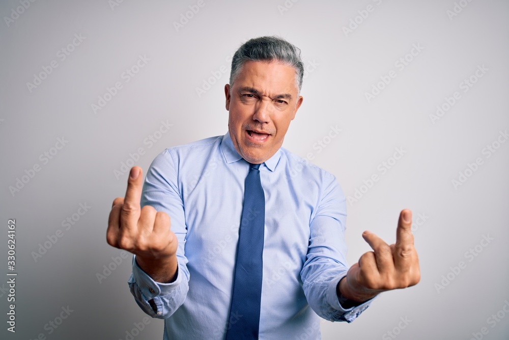 Middle age handsome grey-haired business man wearing elegant shirt and tie Showing middle finger doing fuck you bad expression, provocation and rude attitude. Screaming excited Middle age handsome grey-haired business man wearing elegant shirt and tie Showing middle finger doing fuck you bad expression, provocation and rude attitude. Screaming excited