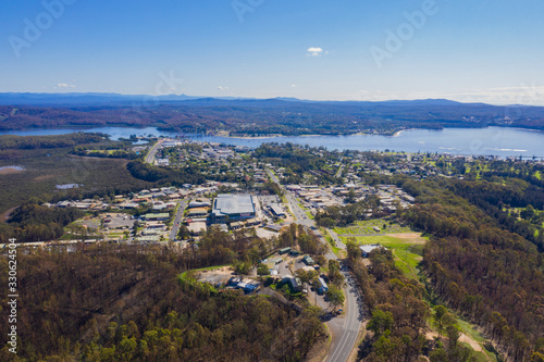 Panoramic aerial drone view of Batemans Bay on the New South Wales South Coast, Australia, looking toward Clyde River and Clyde River Bridge, on a sunny day 