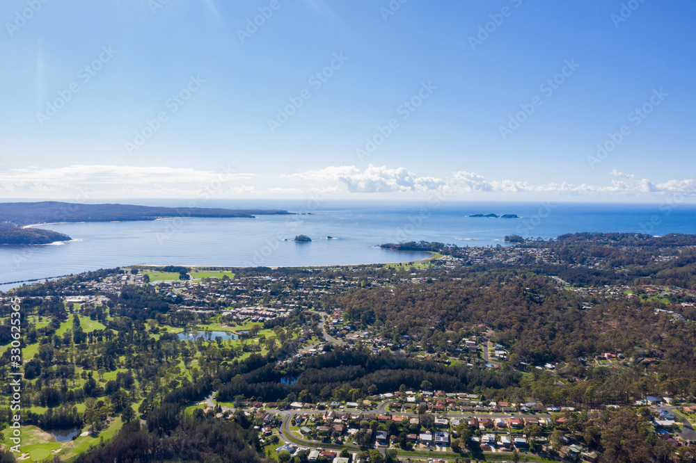 Panoramic aerial drone view of Batemans Bay on the New South Wales South Coast, Australia, looking out to Tasman Sea on a sunny day   