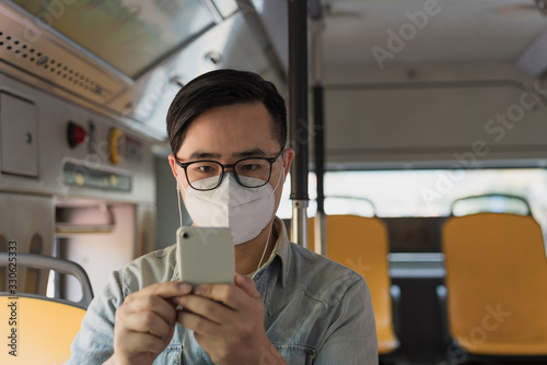 Asian men wearing medical masks on buses