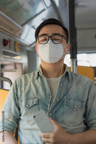 Asian men wearing medical masks on buses photo