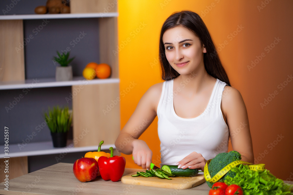 Young beautiful woman preparing wholesome diet salad