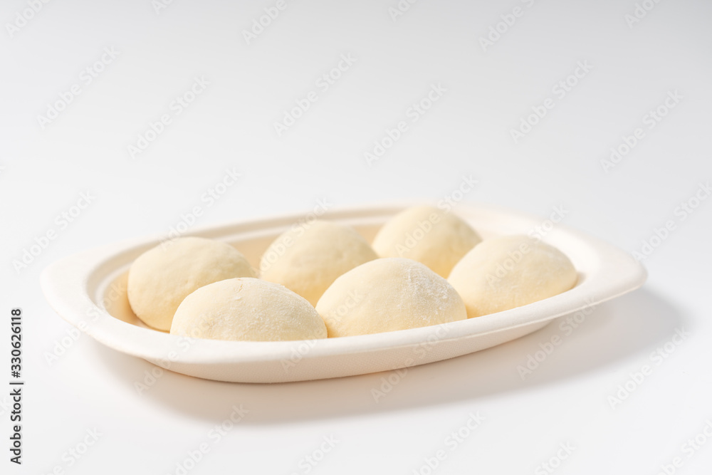 A dish of Chinese bread on a white background