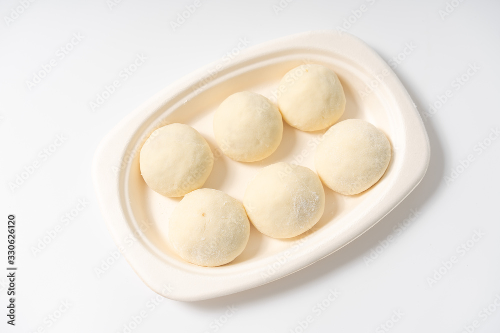 A dish of Chinese bread on a white background