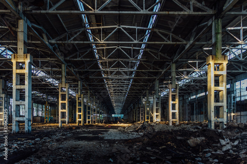 Abandoned large industrial hall with garbage waiting for demolition. Former Voronezh excavator manufacturing factory