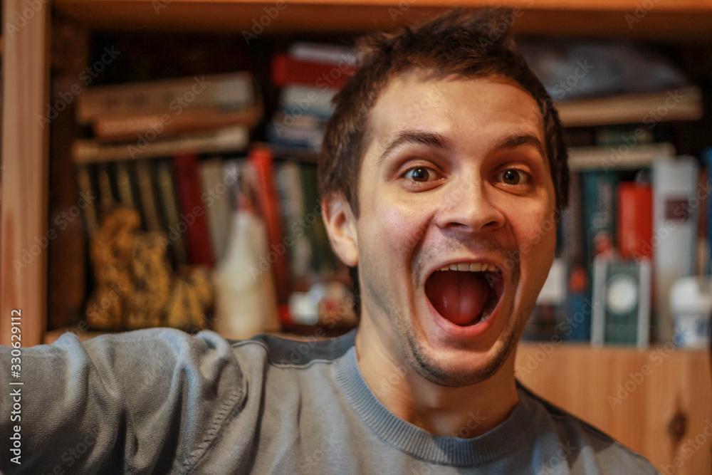 young cute man looking at the camera with open mouth for joy young cute man looking at the camera with open mouth for joy