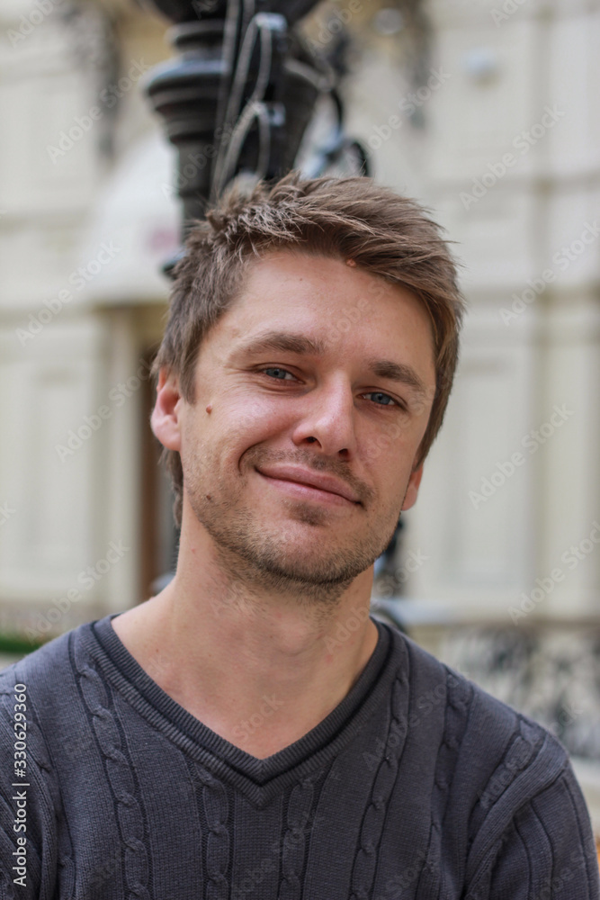 portrait of a young attractive blond smiling guy, front view. portrait of a young attractive blond smiling guy, front view.