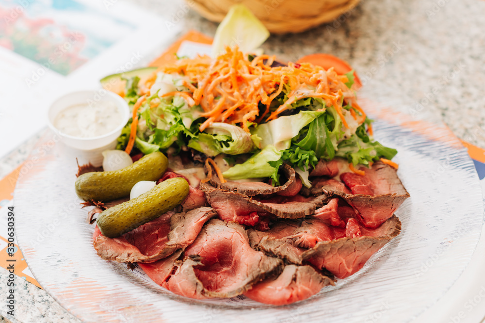 Roastbeef with fresh carrot and green salad served in restaurant Roastbeef with fresh carrot and green salad served in restaurant