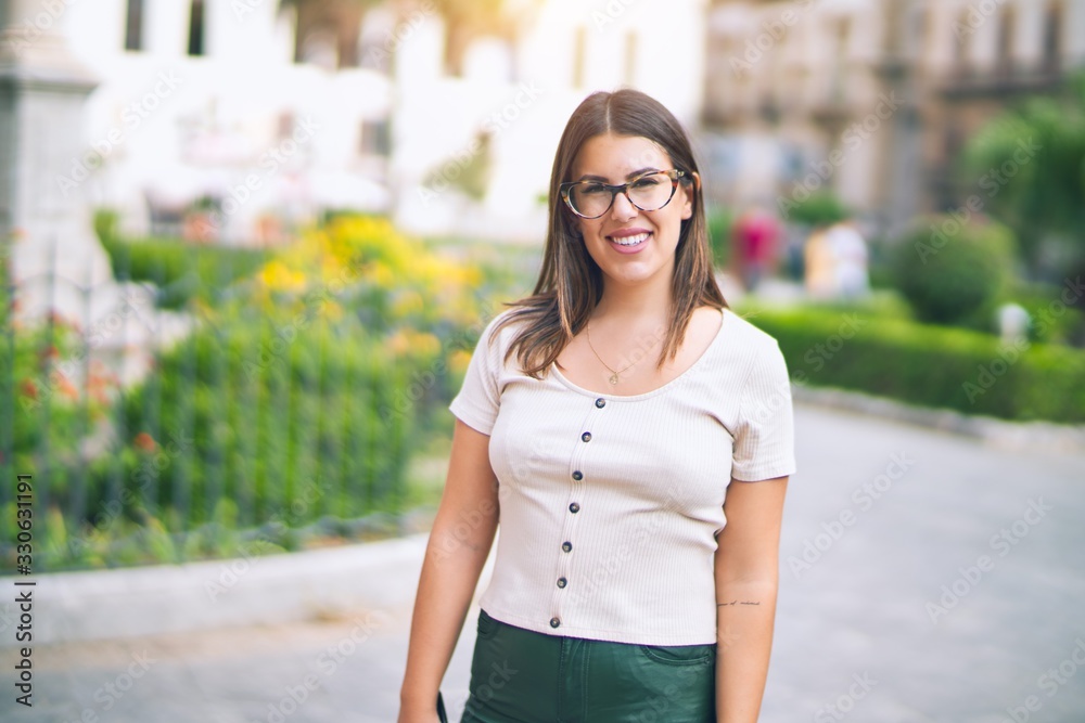 Young beautiful woman smiling happy and confident. Standing with smile on face at the town street Young beautiful woman smiling happy and confident. Standing with smile on face at the town street