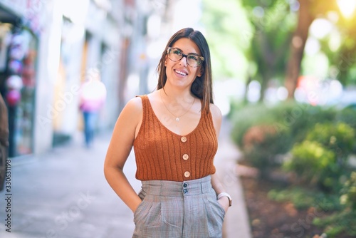 Young beautiful woman smiling happy and confident. Standing with smile on face at the town street © Krakenimages.com